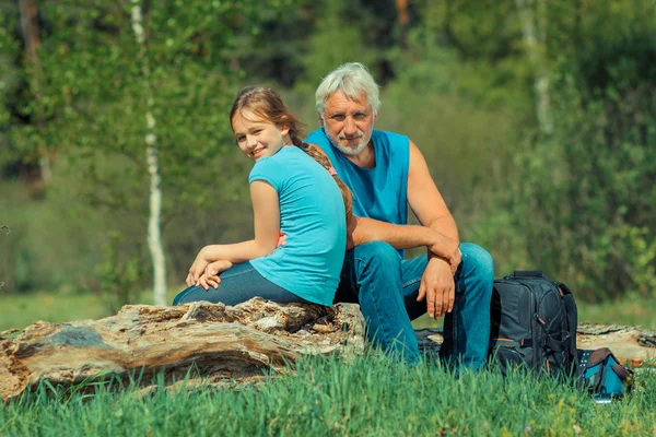 Man with his granddaughter traveling