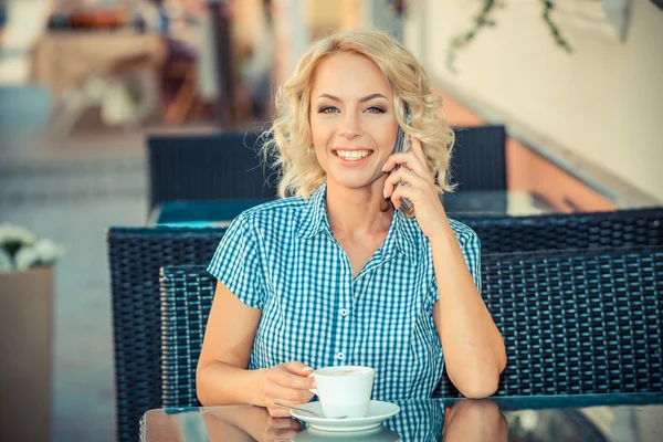 Girl with cup of coffee and phone