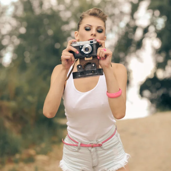 Hipster girl  using vintage camera.