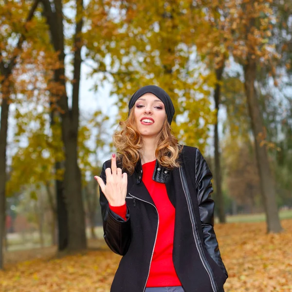 Girl showing obscene gesture outdoor