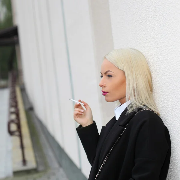 Business woman nervously smoking