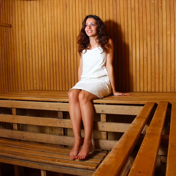 Young woman relaxing in a sauna