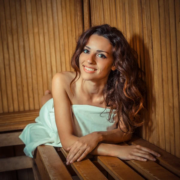 Young woman relaxing in a sauna