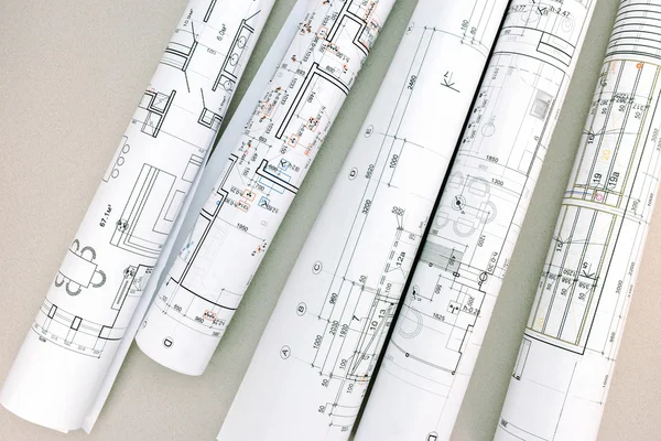 Architectural blueprints and blueprint rolls on desk