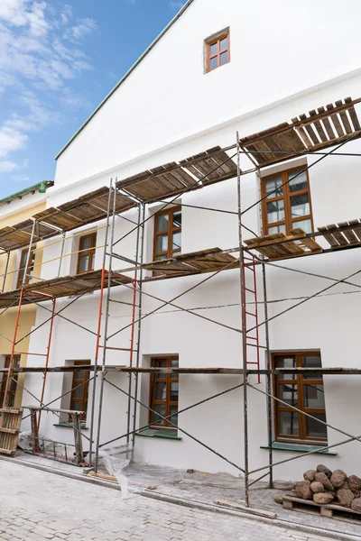 Facade of renovation building with scaffolding