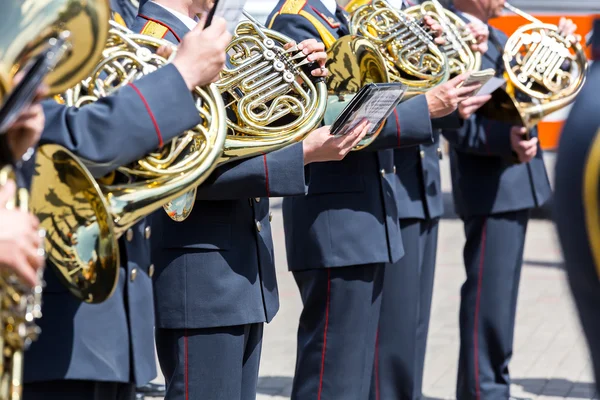 Military musicians with french horns at street concert
