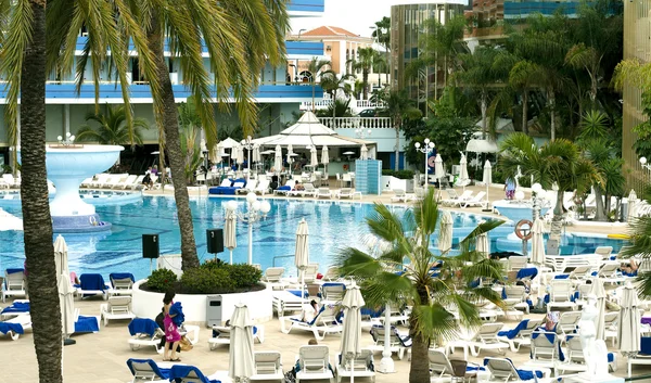 Relax near a swimming-pool in a hotel in Playa de Las Americas