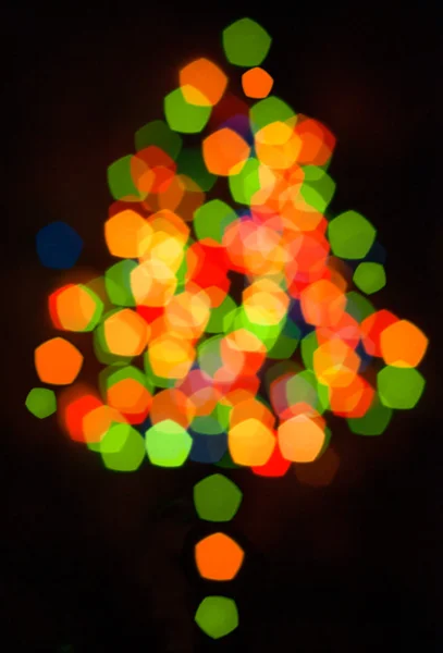 Defocused  multicolored christmas tree silhouette
