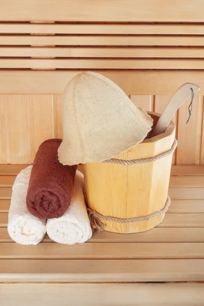 Traditional wooden sauna for relaxation with bucket of water