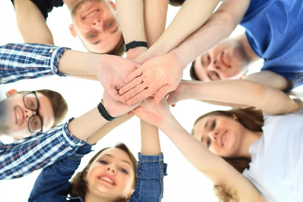 Friendship, youth and people concept - group of smiling teenagers with hands