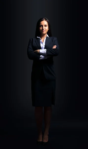 Successful businesswoman isolated on black