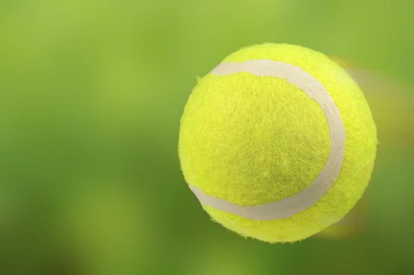 Lawn Tennis Ball in Motion on Green Background