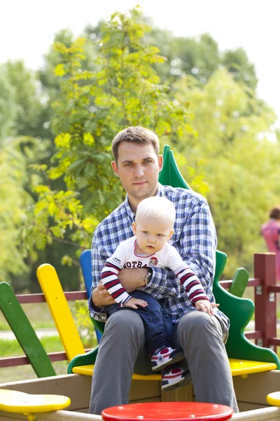 Father with two year old son on the playground