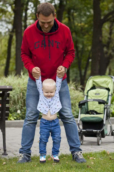 Father with two year old son in summer park
