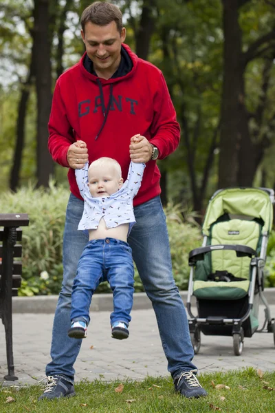 Father with two year old son in summer park