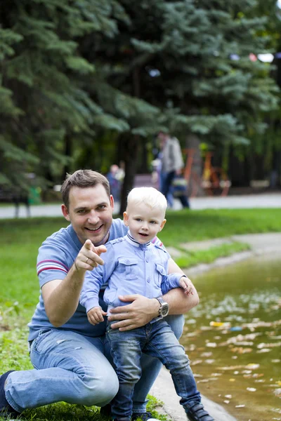 Father with two year old son in summer park