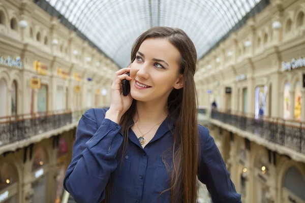 Beautiful young brunette woman calling by phone