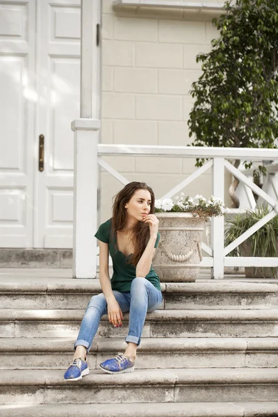 Young beautiful brown haired woman in blue jeans