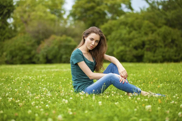 Young beautiful brown haired woman in blue jeans