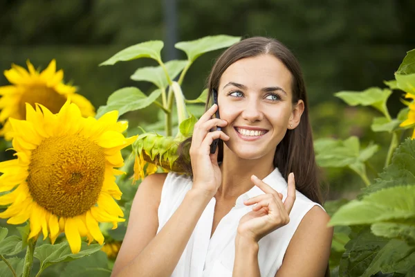 Close-up portrait of beautiful joyful woman with sunflower