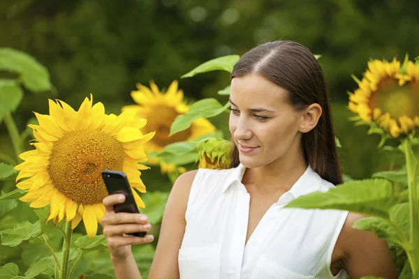 Close-up portrait of beautiful joyful woman with sunflower