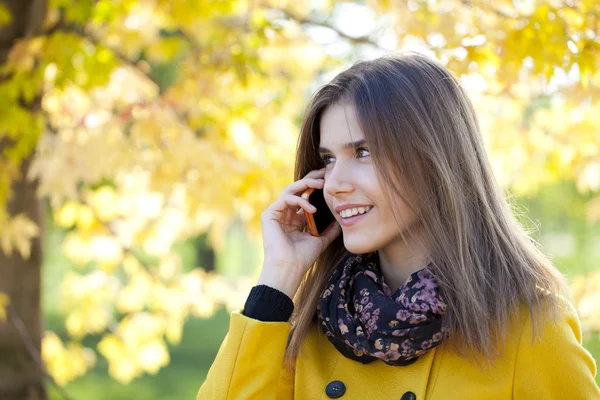Happy beautiful woman calling by phone