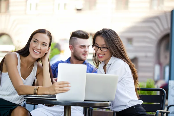 Interracial business team working at laptop in a office outdoor