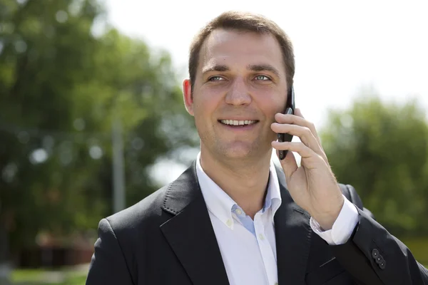 Young urban professional man talking on smartphone