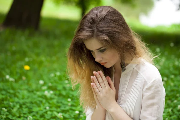 Young beautiful girl praying
