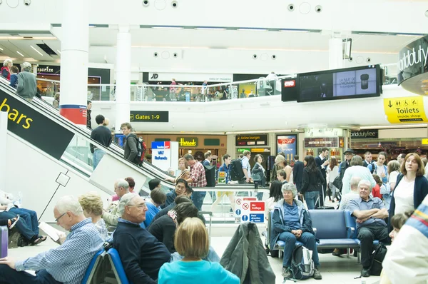 People in hall of Gatwick airport, England