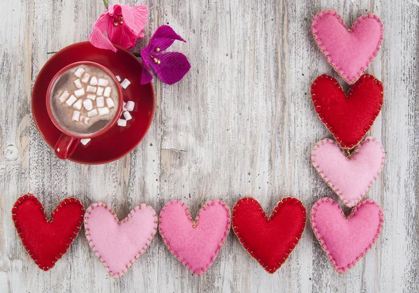 Coffee with marshmallows, paper flowers and hearts