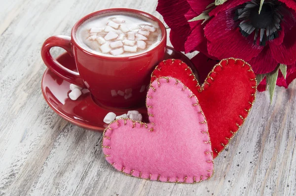 Cocoa with marshmallows, paper flowers and hearts
