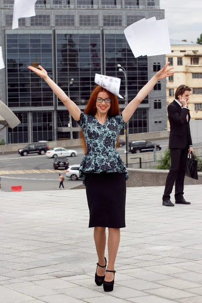 Adult ginger woman throwing papers away