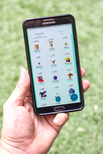 List of pokemons on mobile phone screen.