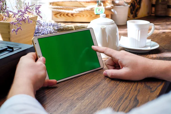 Tablet computer empty screen in man hands. Reading charts, docum