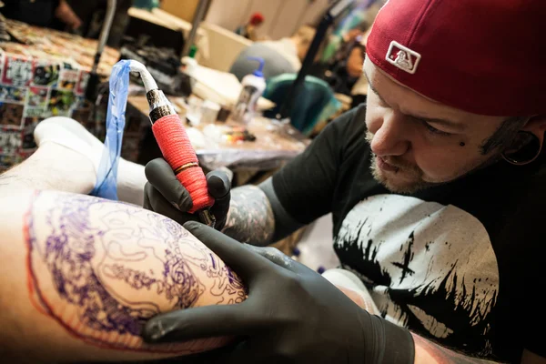 Tattoo artists at work