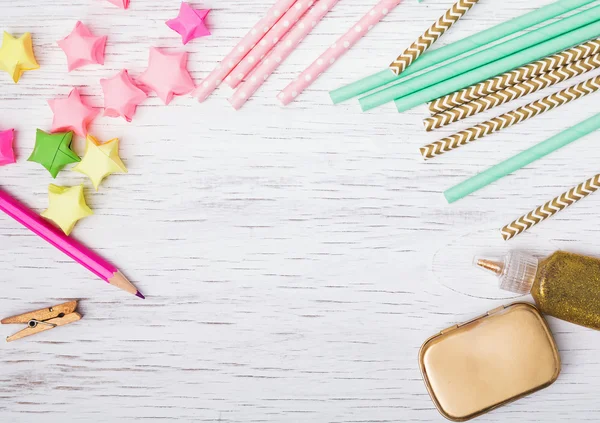 Paper straws and stars on white background