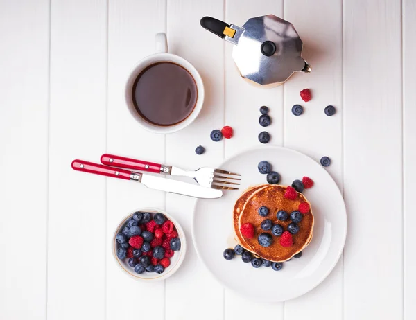 Breakfast with pancakes, berries and coffee