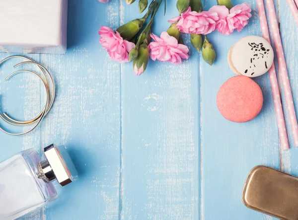 Cute feminine objects on blue colored table