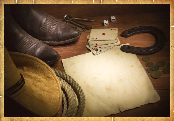 American west background with poker cards and cowboy objects