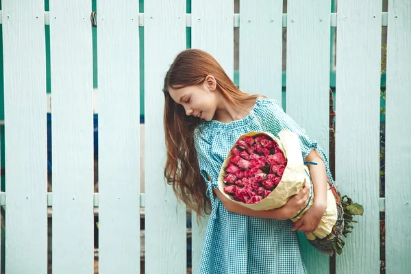 Tween girl holding bunch of roses