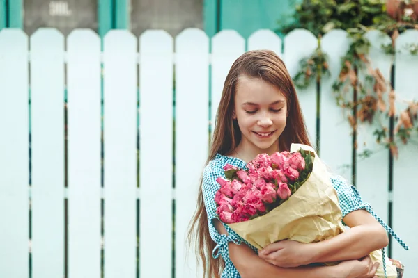 Tween girl holding bunch of roses