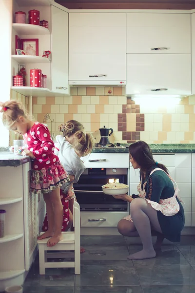 Mother with kids at the kitchen