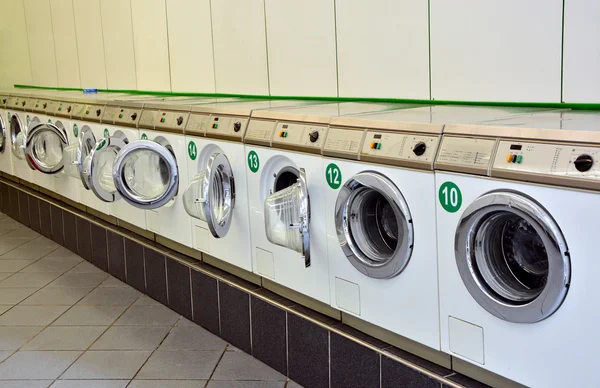 Row of washing machines in a public laundromat