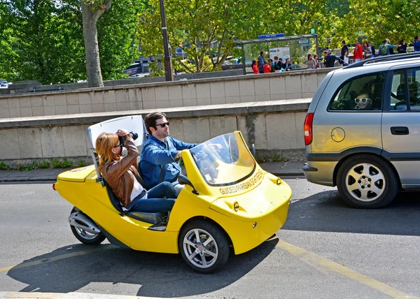 Tourists on a rented car photographed attractions on August 22,2014 in Paris, France. Cars with navigation system and audio guide, have already attracted many tourists