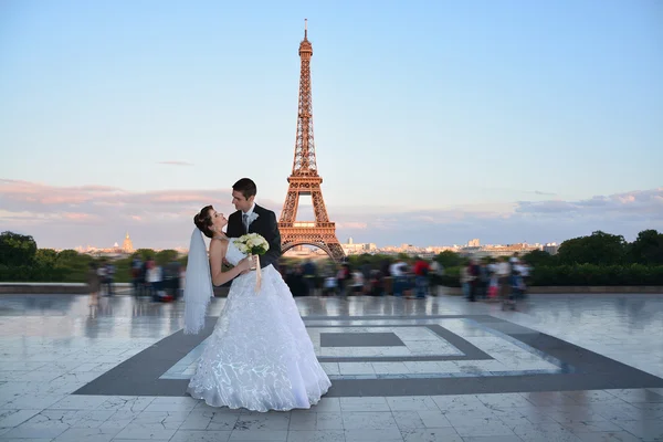 Beautiful wedding couple. Bride and groom in front of the Eiffel Tower in Paris. Retro Style