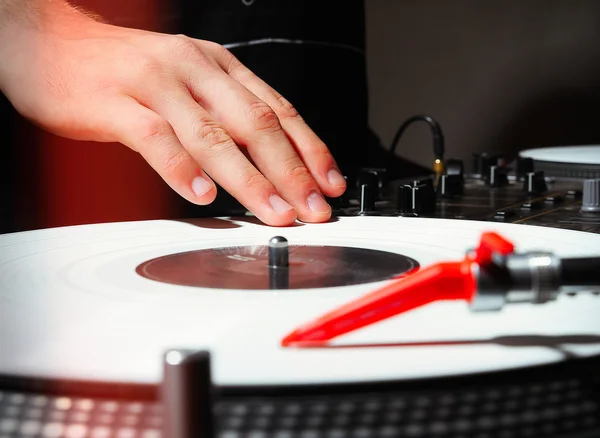 Hands of DJ pplaying music on vinyl records
