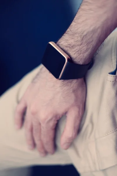 Man with a smart wrist watch on hand