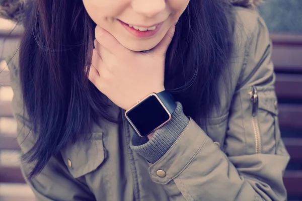 Smiling girl with smart watch