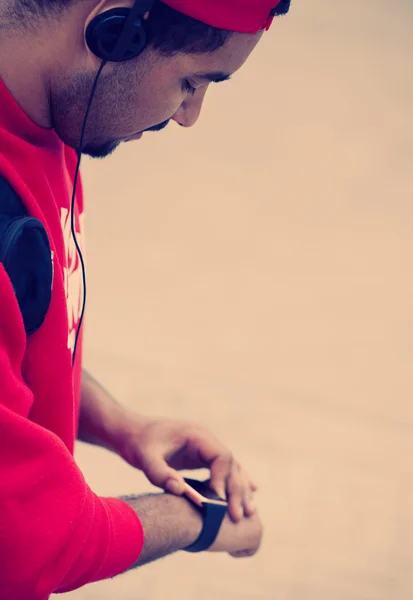 Young black guy using smart wrist watch